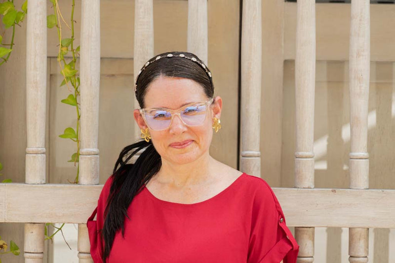 Woman in red wearing clear Klair frames